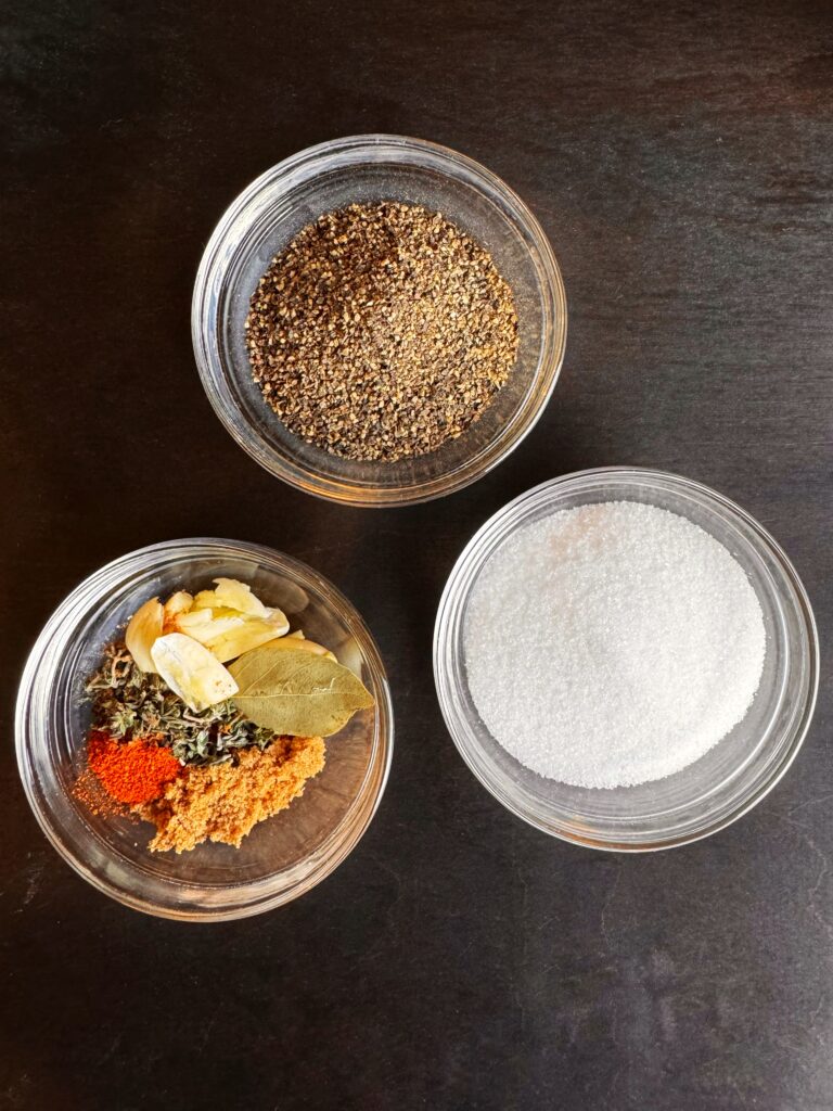 photo of a bowl of salt, a bowl of black pepper, and a bowl of spices for beef Guinness stew