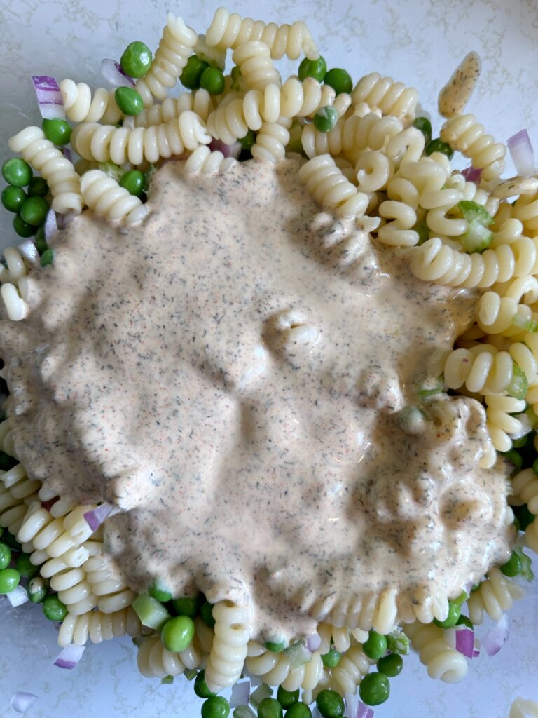 a photo of creamy pasta salad with peas before being mixed